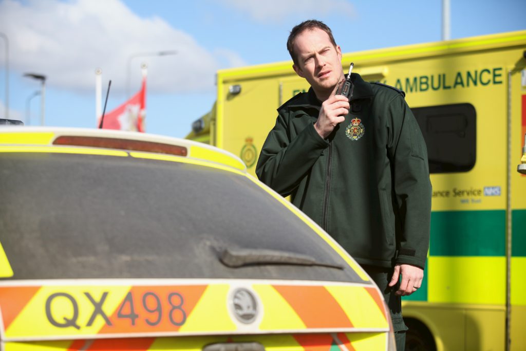 Advanced paramedic stood in front of ambulance. 