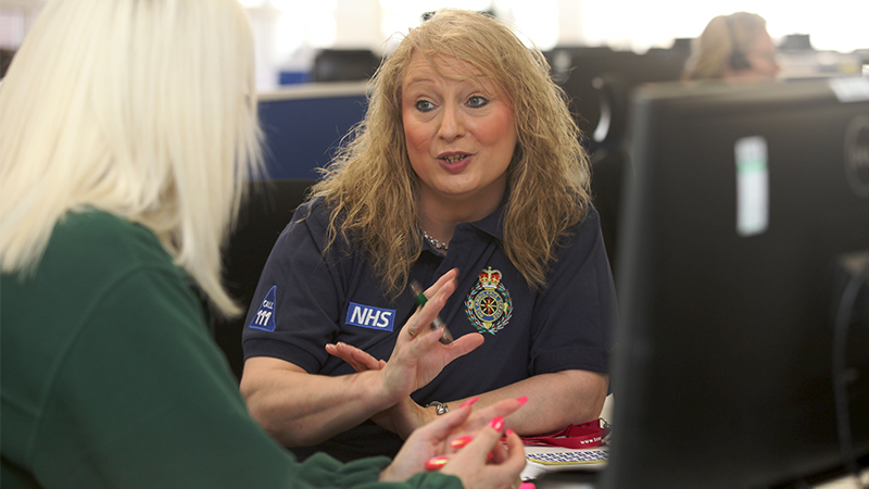 Female senior clinical advisor speaking with a colleague.