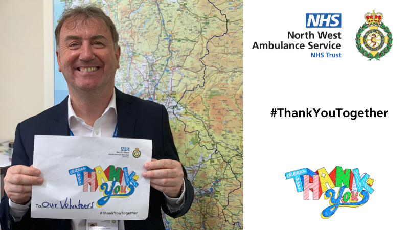 Deputy CEO Mick Forrest holding up a thank you poster dedicated to our volunteers