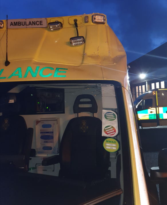 Extensive damage to the cab and emergency lights of an ambulance
