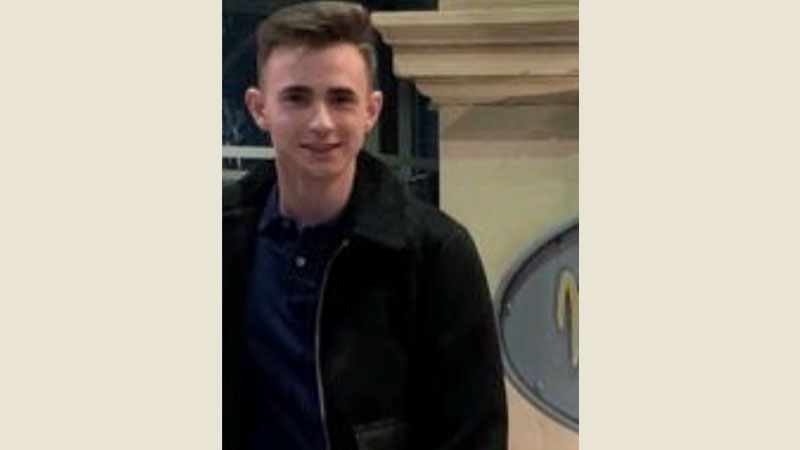 16 year old Oscar wearing a black coat