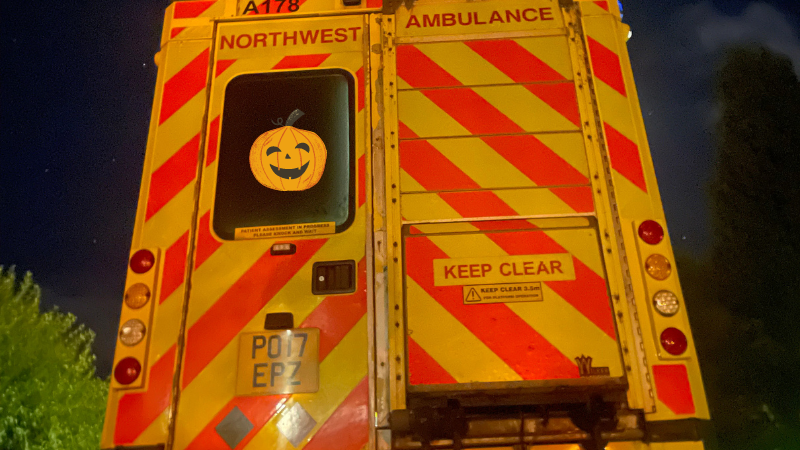 Rear of ambulance with pumpkin face in the window
