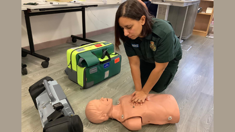 Apprentice paramedic Vicky practicing CPR on a dummy