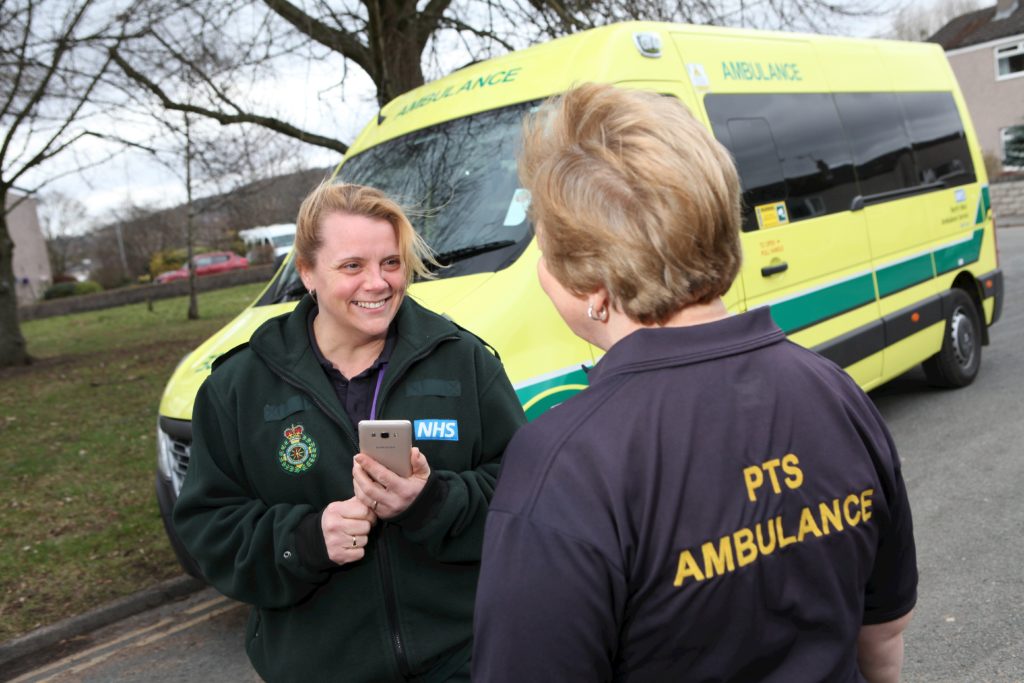 Two Patient Transport Service ladies stood talking.