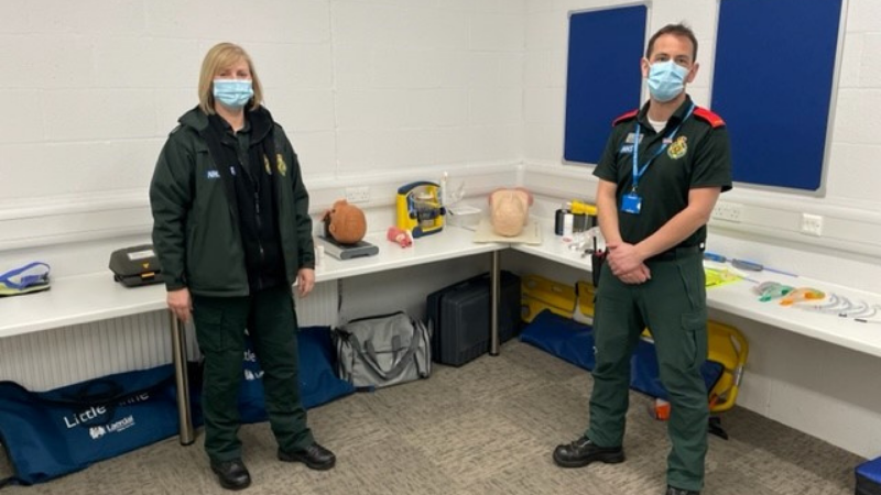 Chris Grant, Executive Medical Director and Maxine Power, Director of Quality, Innovation and Improvement stood in their green uniforms in the new clinical simulation suite.