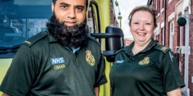 Two paramedics stood infront of an ambulance vehicle