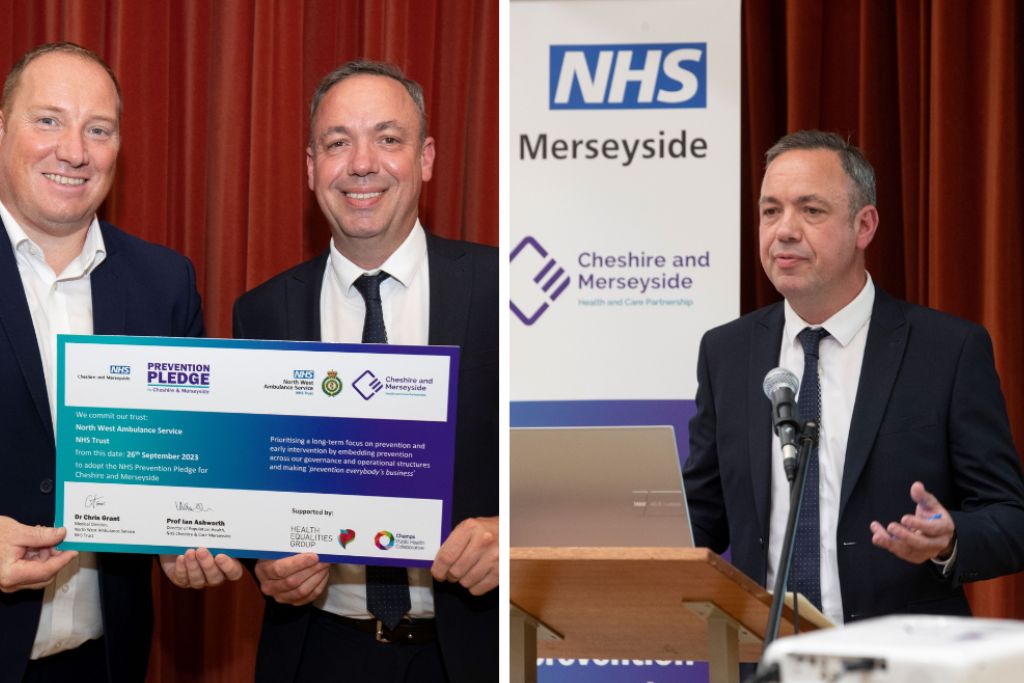 A photo of two men smiling with pledge certificate besides a man in a suit holding a speech.