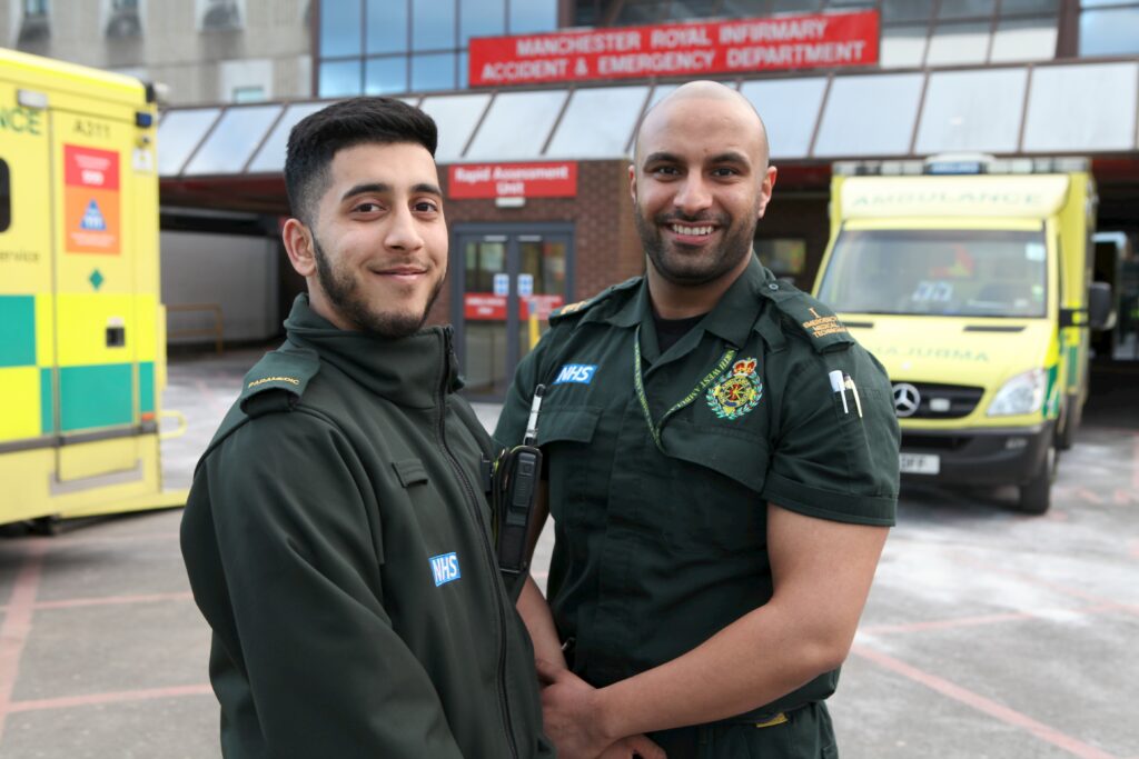 Two paramedics stood in front of A&E.