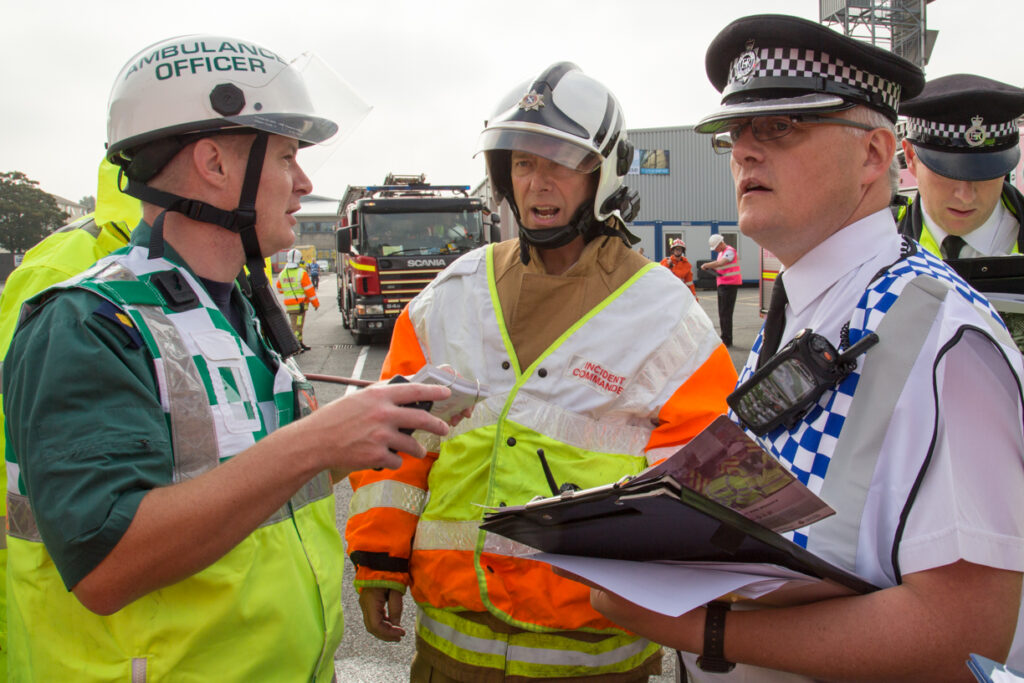 Police, Fire and Ambulance staff talking