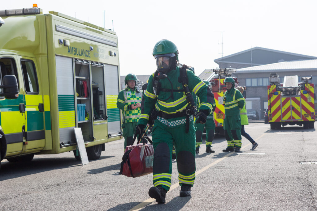 Fireman walking with equipment.