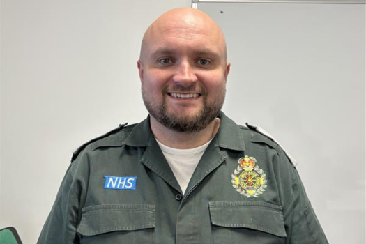 ambulance staff member in uniform smiling at camera