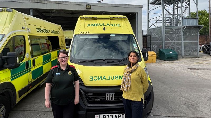 Sector Clinical Lead Natalie and Public Health Manager Claudia stood in front of an ambulance.