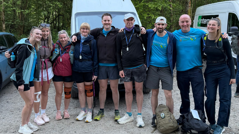 Group of people in walking gear smiling at the camera