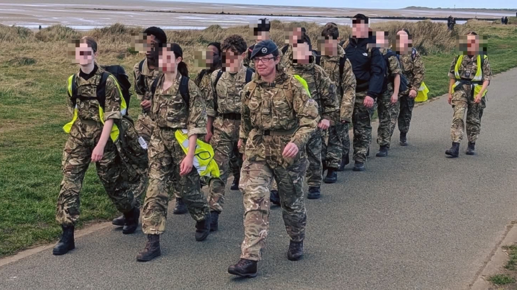 A group of young people in military-style uniform with Becky leading from the front