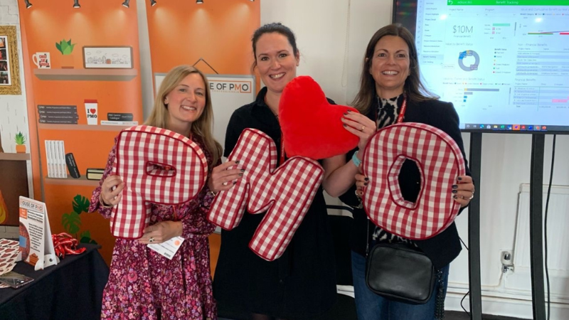 Members of the PMO team holding 'PMO' letters.