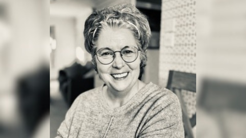 Retired nurse Edwina. Edwina is female wearing glasses.