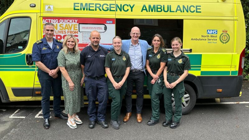 Group of staff in front of an ambulance