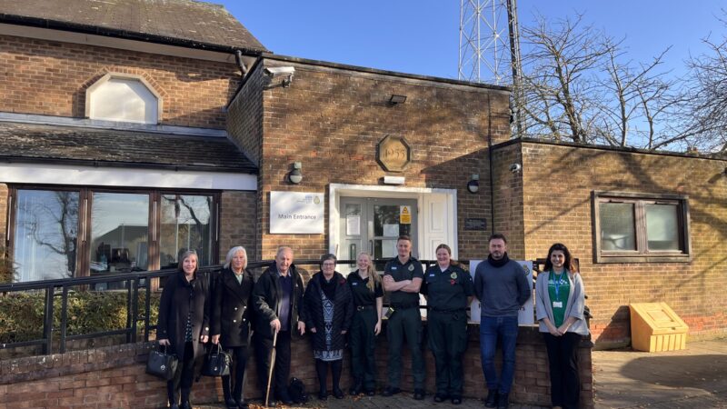 Cumbrian cardiac arrest survivor and group are photographed outside the main entrance