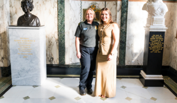 Ambulance Cadet Jasmine (left) and Abbey (right) stood in an official building with marble walls.