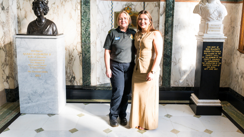Ambulance Cadet Jasmine (left) and Abbey (right) stood in an official building with marble walls.