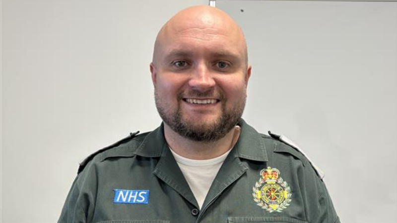 ambulance staff member in uniform smiling at camera