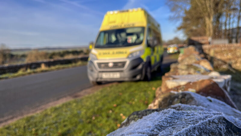 Frost covered wall in front of a blurred out ambulance