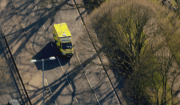 Birds eye view of an ambulance driving along a road
