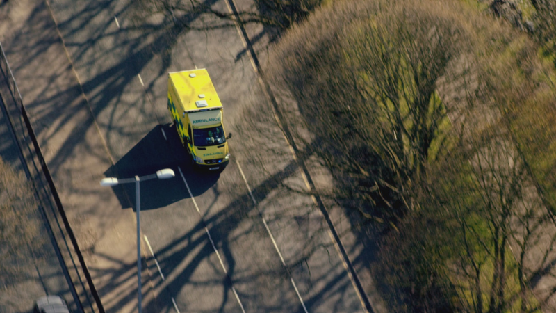 Birds eye view of an ambulance driving along a road