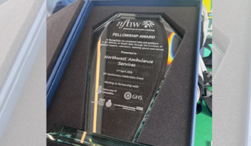 A glass award presented it's box.