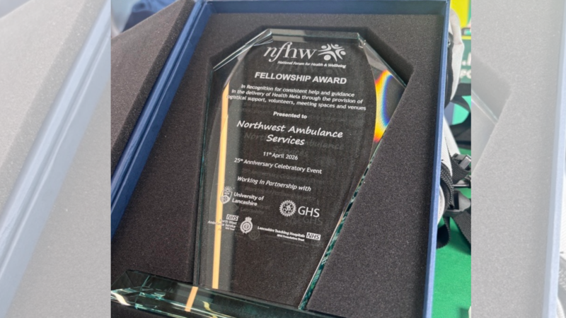 A glass award presented it's box.