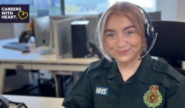 Female call handler wearing a headset smiling at the camera.