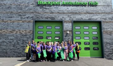 A group of volunteers stand outside Blackpool Ambulance Hub after a successful litter pick.