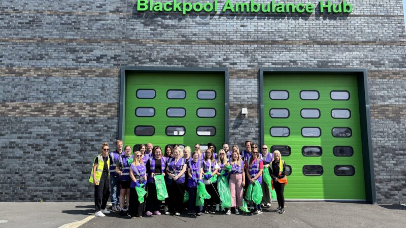 A group of volunteers stand outside Blackpool Ambulance Hub after a successful litter pick.