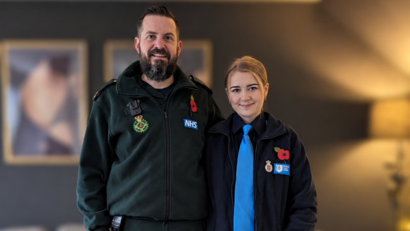 Two people in uniform; one NWAS uniform and the other a cadet uniform. Both are wearing poppies