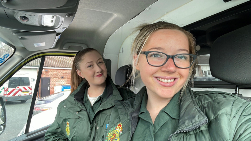 Student Paramedic Laura with her colleague in the cab of a patient transport service ambulance.