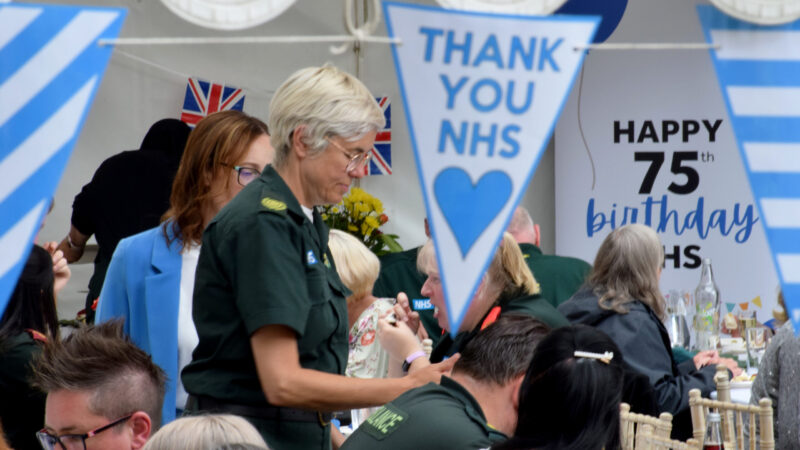 Group of staff inside marquee celebrating NHS 75th birthday