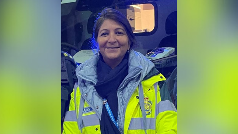 A woman in a high visibility jacket smiling