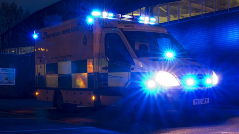 Ambulance in the dark with blue flashing lights