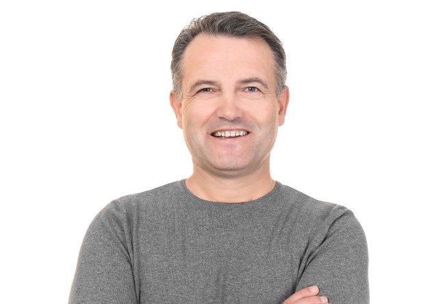 Stock image of middle aged man in grey shirt